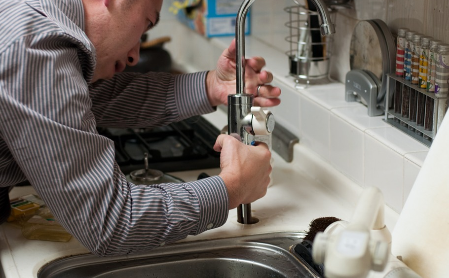 man fixing tap